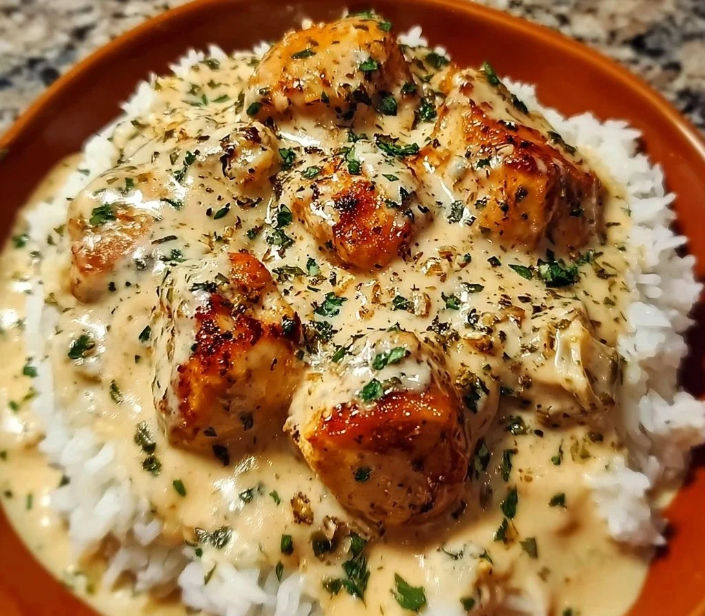 Creamy smothered chicken served with rice in a delicious sauce